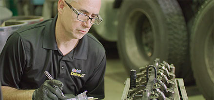 Technician working on a truck in a garage