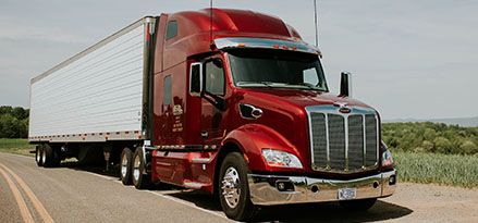 Red truck driving on road