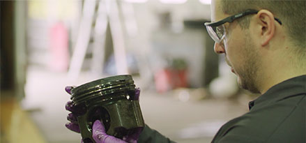 A technician analyzing part of a truck part