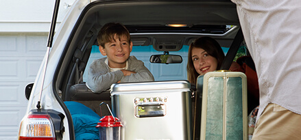 two girls arms crossed back seat car preparing family road trip